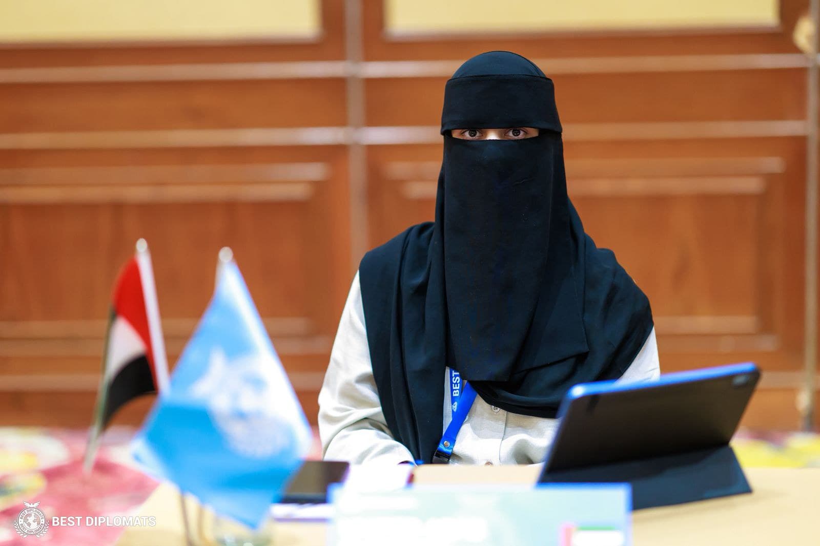 Areesha Sheikh representing at an international diplomacy conference, wearing a black niqab.